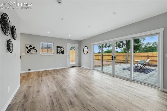 1112 Modes St, Colorado Springs, CO 80904 - unfurnished living room with plenty of natural light, light wood finished floors, baseboards, and recessed lighting