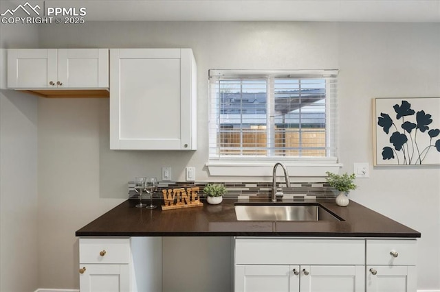 1112 Modes St, Colorado Springs, CO 80904 - kitchen featuring a sink, dark countertops, and white cabinetry