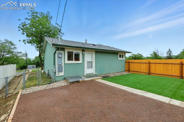 1112 Modes St, Colorado Springs, CO 80904 - rear view of house with stucco siding, a gate, and roof with shingles