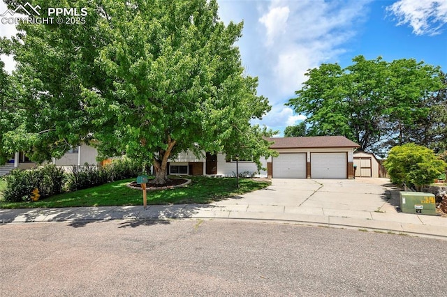 4059 Cooke Ln, Colorado Springs, CO 80911 - view of property hidden behind natural elements featuring an attached garage, driveway, and a front lawn