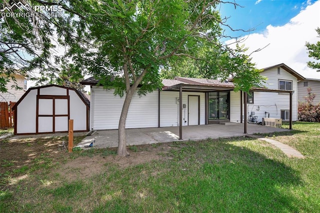 4059 Cooke Ln, Colorado Springs, CO 80911 - back of house featuring a patio, a storage unit, and a lawn