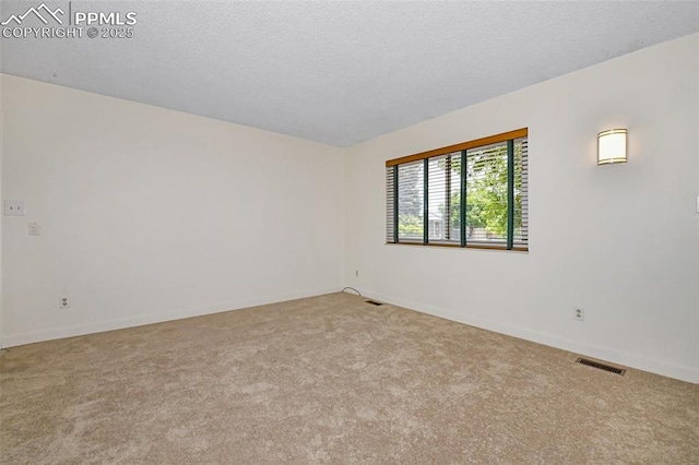 4059 Cooke Ln, Colorado Springs, CO 80911 - carpeted spare room featuring baseboards and a textured ceiling