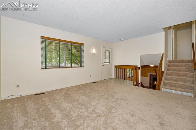4059 Cooke Ln, Colorado Springs, CO 80911 - empty room featuring carpet, a textured ceiling, and stairs