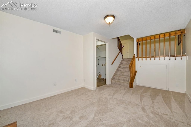 4059 Cooke Ln, Colorado Springs, CO 80911 - carpeted spare room featuring stairs and a textured ceiling