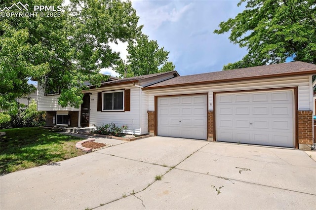 4059 Cooke Ln, Colorado Springs, CO 80911 - split level home featuring driveway, brick siding, an attached garage, and a front lawn