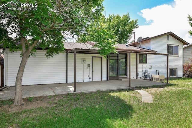 4059 Cooke Ln, Colorado Springs, CO 80911 - rear view of property featuring a patio, a yard, and a shingled roof