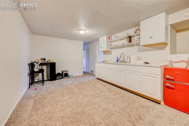 3118 E Ln Salle St, Colorado Springs, CO 80909 - miscellaneous room featuring a textured ceiling, bar with sink, and carpet floors