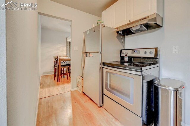 3118 E Ln Salle St, Colorado Springs, CO 80909 - kitchen featuring under cabinet range hood, stainless steel range with electric stovetop, light wood-style floors, and white cabinets