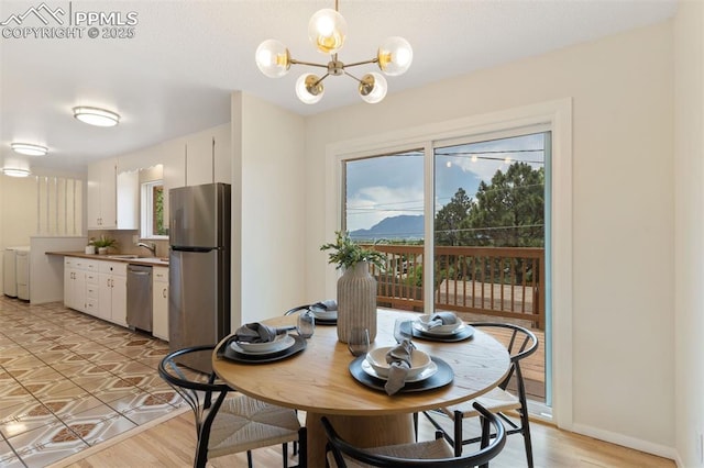 1411 Acacia Dr, Colorado Springs, CO 80907 - dining area featuring a chandelier and light wood-type flooring