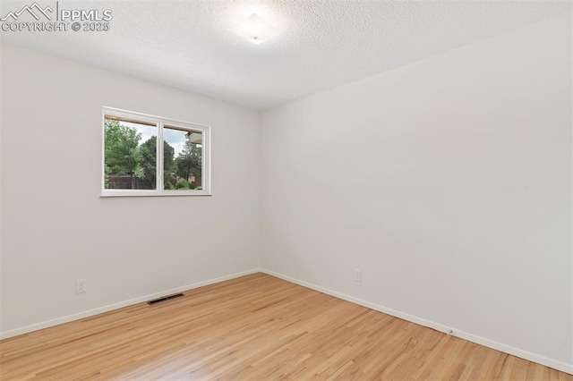 1411 Acacia Dr, Colorado Springs, CO 80907 - empty room with wood finished floors and a textured ceiling