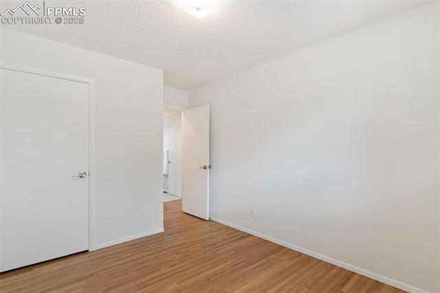 1411 Acacia Dr, Colorado Springs, CO 80907 - unfurnished bedroom featuring light wood finished floors and baseboards
