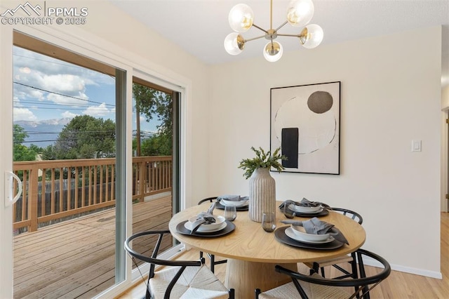 1411 Acacia Dr, Colorado Springs, CO 80907 - dining space with light wood-type flooring and a chandelier