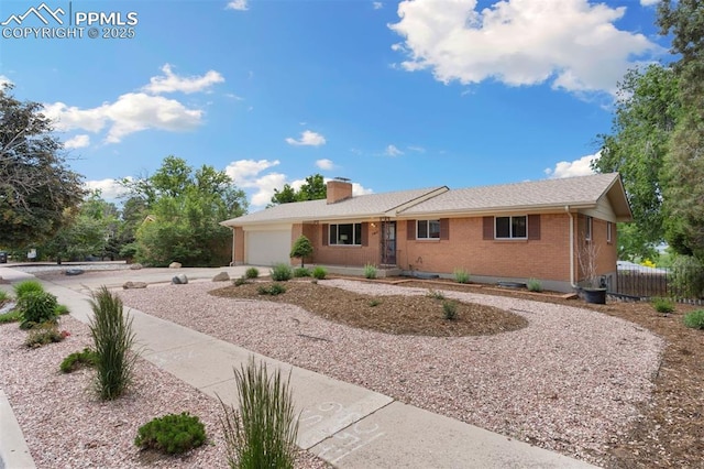 1411 Acacia Dr, Colorado Springs, CO 80907 - ranch-style house featuring brick siding, an attached garage, a chimney, and concrete driveway