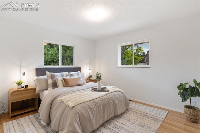 1411 Acacia Dr, Colorado Springs, CO 80907 - bedroom featuring light wood-style flooring and a textured ceiling