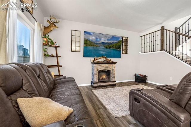 11434 Whistling Duck Way, Colorado Springs, CO 80925 - living area featuring wood finished floors, stairs, and a stone fireplace