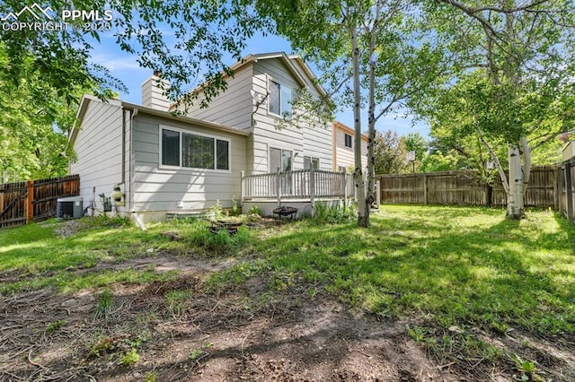 5105 Stellar Dr, Colorado Springs, CO 80923 - back of house with a chimney, a fenced backyard, and a deck