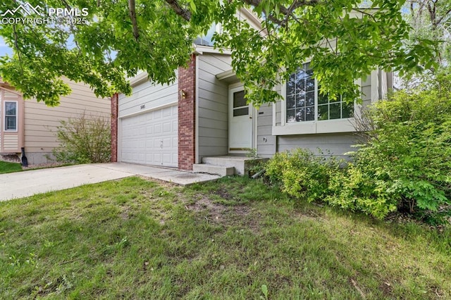 5105 Stellar Dr, Colorado Springs, CO 80923 - obstructed view of property featuring brick siding, driveway, a garage, and a front yard