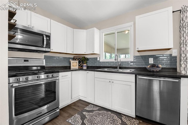 519 Crest St, Fountain, CO 80817 - kitchen with appliances with stainless steel finishes, dark countertops, tasteful backsplash, and white cabinetry