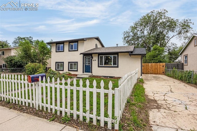 519 Crest St, Fountain, CO 80817 - tri-level home featuring stucco siding, a fenced front yard, and driveway