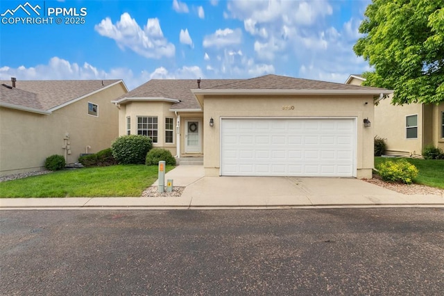 3320 Chestnut Glen Ln, Colorado Springs, CO 80918 - view of front of property with driveway, a garage, a front yard, and stucco siding