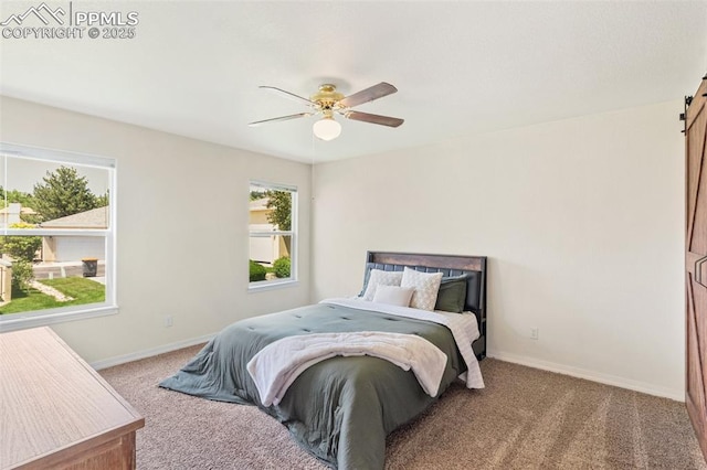 3320 Chestnut Glen Ln, Colorado Springs, CO 80918 - bedroom with a barn door, carpet flooring, baseboards, and a ceiling fan
