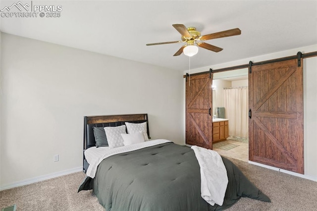 3320 Chestnut Glen Ln, Colorado Springs, CO 80918 - bedroom with a barn door, light carpet, baseboards, and ensuite bath