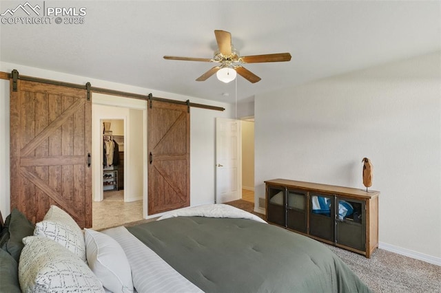 3320 Chestnut Glen Ln, Colorado Springs, CO 80918 - bedroom with a barn door, baseboards, a spacious closet, and ceiling fan
