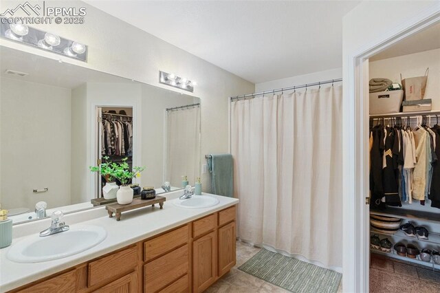 3320 Chestnut Glen Ln, Colorado Springs, CO 80918 - bathroom with double vanity and a walk in closet