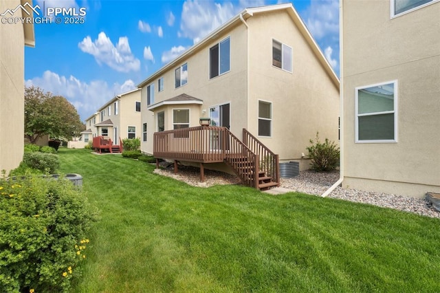 3320 Chestnut Glen Ln, Colorado Springs, CO 80918 - back of house with a wooden deck, a yard, stucco siding, and a residential view