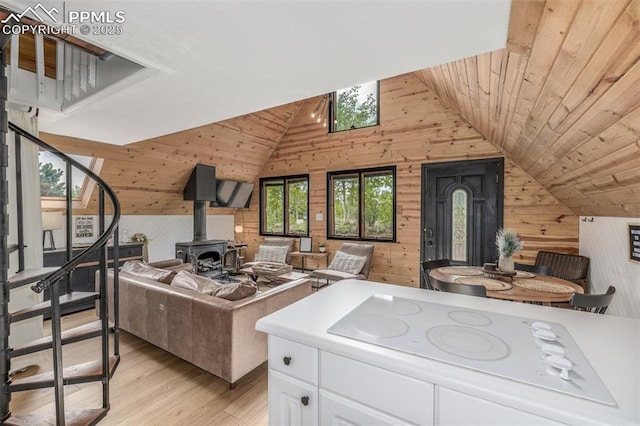 860 Golden Cycle Cir, Cripple Creek, CO 80813 - living room with wood walls, stairway, light wood finished floors, vaulted ceiling, and wood ceiling