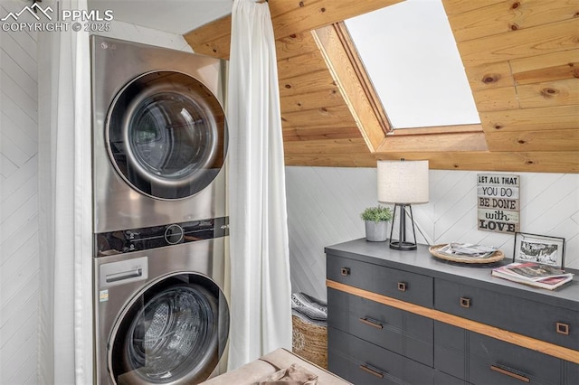 860 Golden Cycle Cir, Cripple Creek, CO 80813 - laundry area with stacked washing machine and dryer, wooden walls, and a skylight