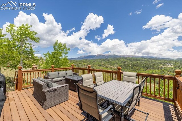 860 Golden Cycle Cir, Cripple Creek, CO 80813 - wooden deck featuring outdoor lounge area, a mountain view, and outdoor dining area
