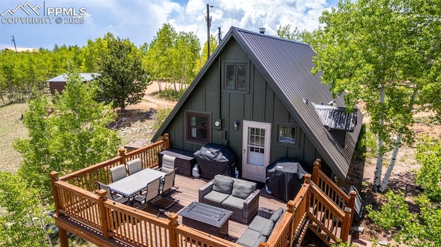 860 Golden Cycle Cir, Cripple Creek, CO 80813 - rear view of property with board and batten siding, a deck, a metal roof, outdoor dining space, and an outdoor hangout area