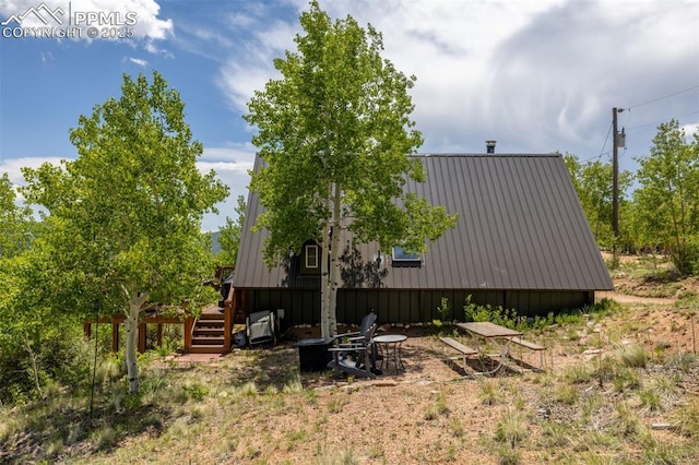860 Golden Cycle Cir, Cripple Creek, CO 80813 - view of home's exterior with a metal roof and stairway