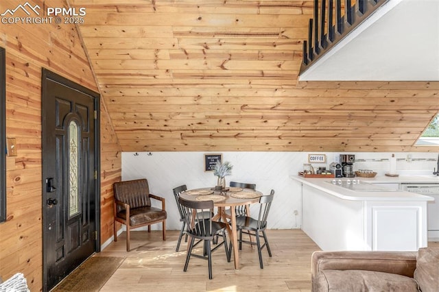 860 Golden Cycle Cir, Cripple Creek, CO 80813 - dining space with wood walls, vaulted ceiling, light wood-style flooring, and wood ceiling
