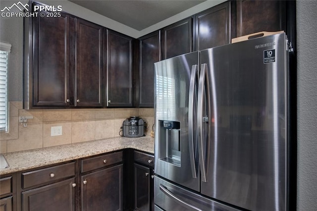 2485 Falkirk Dr, Colorado Springs, CO 80910 - kitchen featuring stainless steel refrigerator with ice dispenser, dark brown cabinetry, and backsplash
