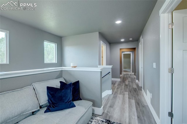 2485 Falkirk Dr, Colorado Springs, CO 80910 - hallway featuring baseboards, light wood-style floors, an upstairs landing, recessed lighting, and a textured ceiling