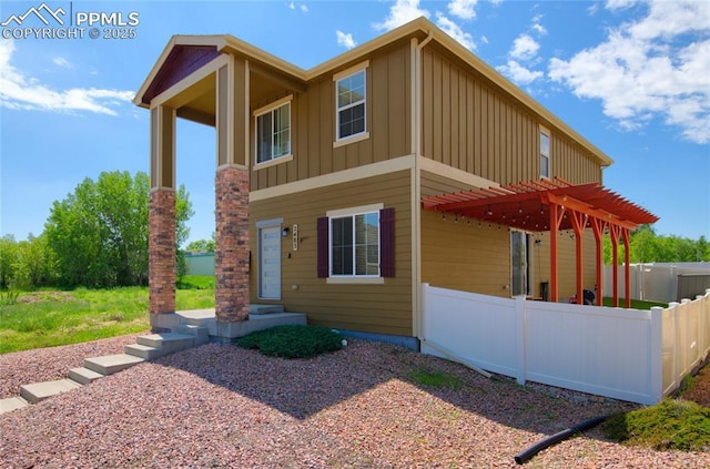 2485 Falkirk Dr, Colorado Springs, CO 80910 - view of front of house with board and batten siding and a pergola