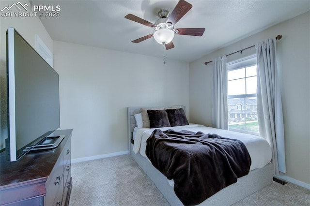 2485 Falkirk Dr, Colorado Springs, CO 80910 - bedroom with light carpet, a ceiling fan, and baseboards