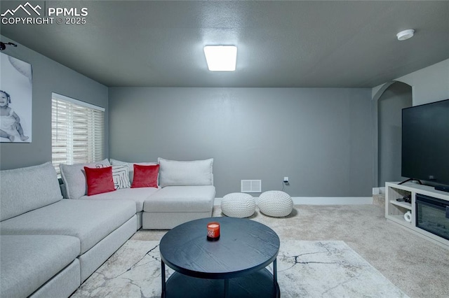 2485 Falkirk Dr, Colorado Springs, CO 80910 - carpeted living area with arched walkways and baseboards