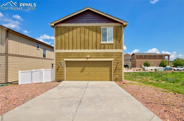 2485 Falkirk Dr, Colorado Springs, CO 80910 - view of front facade featuring board and batten siding, driveway, and an attached garage