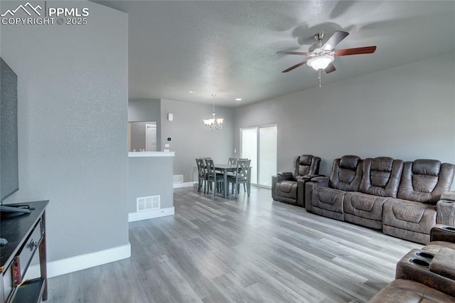 2485 Falkirk Dr, Colorado Springs, CO 80910 - living area with a chandelier, baseboards, ceiling fan, wood finished floors, and a textured ceiling
