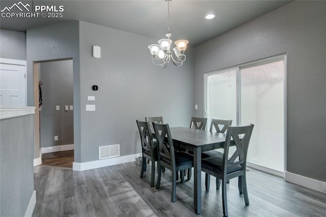 2485 Falkirk Dr, Colorado Springs, CO 80910 - dining area with wood finished floors, a chandelier, baseboards, and a textured wall