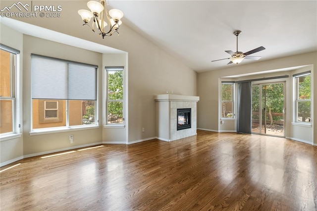 4410 Campus Bluffs Ct, Colorado Springs, CO 80918 - unfurnished living room with a chandelier, wood finished floors, a fireplace, lofted ceiling, and a ceiling fan