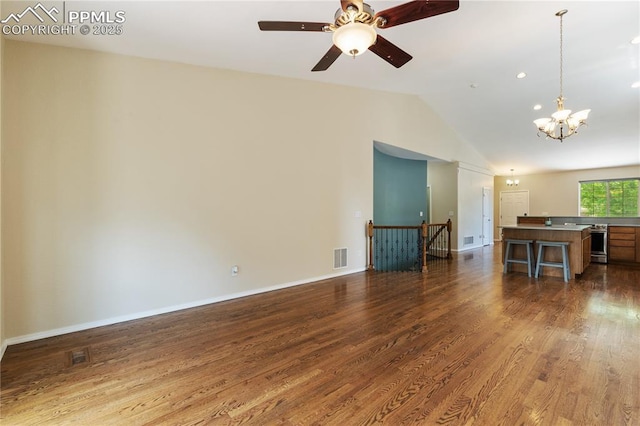 4410 Campus Bluffs Ct, Colorado Springs, CO 80918 - unfurnished living room with lofted ceiling, a chandelier, dark wood-type flooring, and a ceiling fan