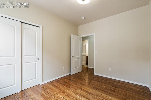 4410 Campus Bluffs Ct, Colorado Springs, CO 80918 - unfurnished bedroom featuring wood finished floors and a closet