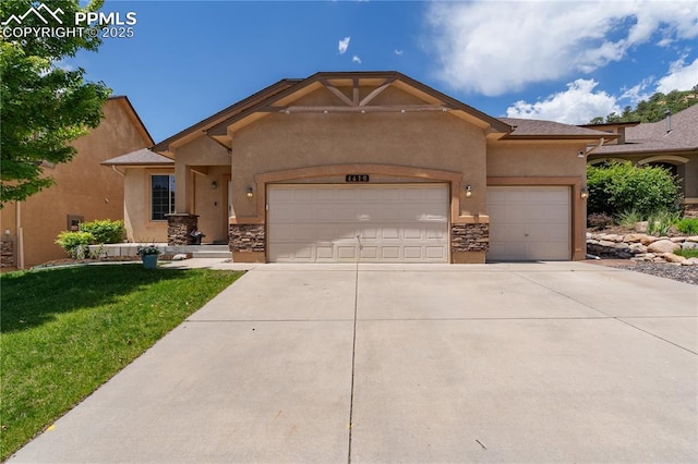 4410 Campus Bluffs Ct, Colorado Springs, CO 80918 - view of front of home with a garage, concrete driveway, stucco siding, and stone siding