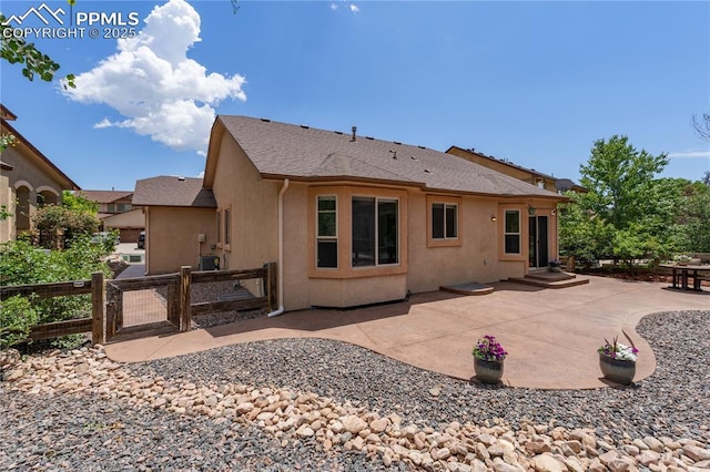 4410 Campus Bluffs Ct, Colorado Springs, CO 80918 - rear view of property featuring a patio area, stucco siding, and a gate