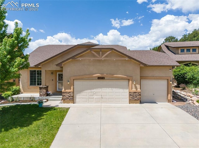 4410 Campus Bluffs Ct, Colorado Springs, CO 80918 - view of front of property featuring a garage, stucco siding, stone siding, and driveway