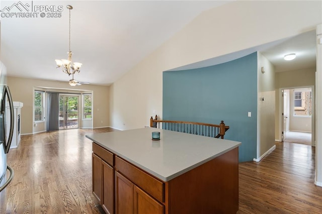 4410 Campus Bluffs Ct, Colorado Springs, CO 80918 - kitchen with lofted ceiling, a chandelier, dark wood-style floors, a kitchen island, and decorative light fixtures